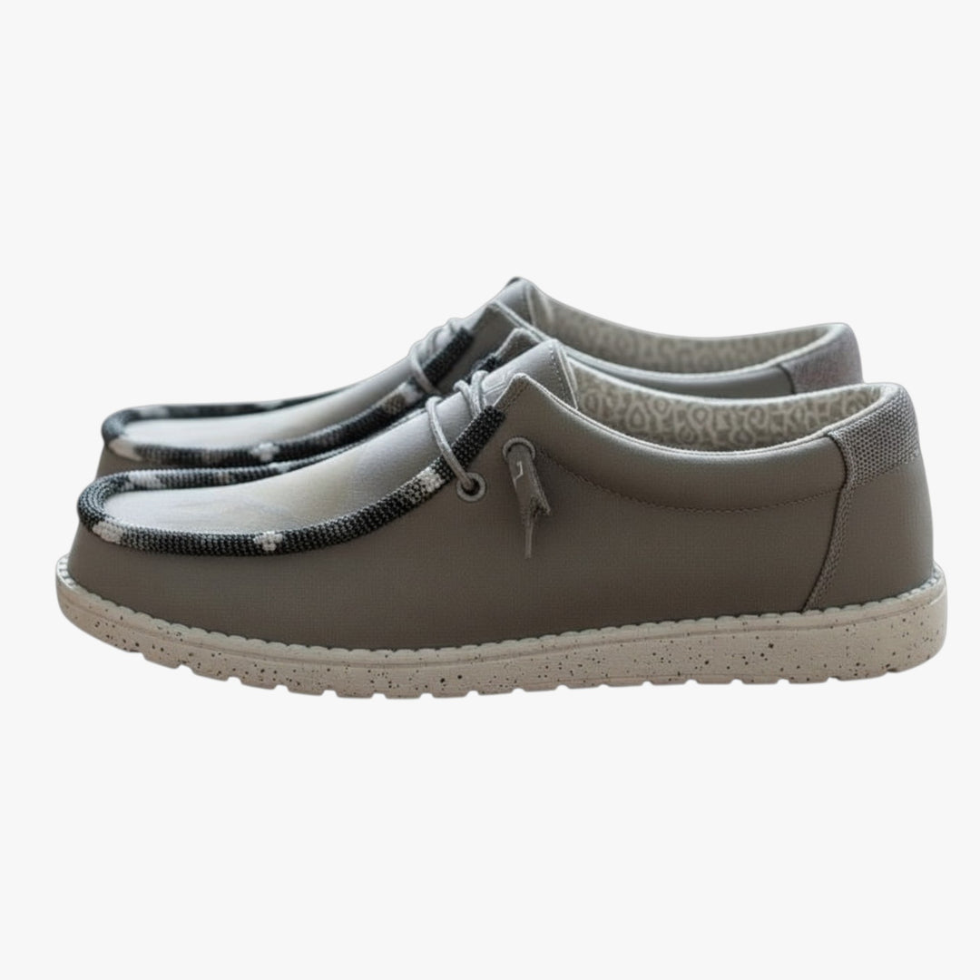 All Nations Designs &amp; More light gray Hey Dude slip-on shoes featuring custom hand-beaded trim on a speckled white sole.