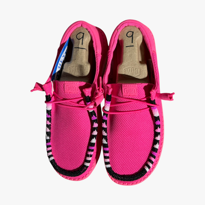 All Nations Designs &amp; More hand-beaded electric pink mesh Hey Dude slip-on shoes with black and white bead accents.