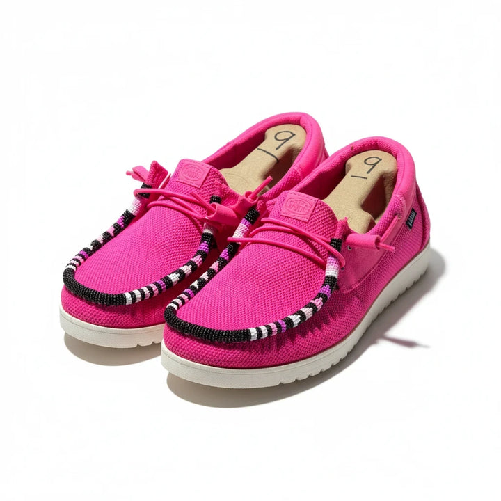 All Nations Designs &amp; More electric pink mesh Hey Dude slip-on shoes with unique hand-beaded trim on a white background