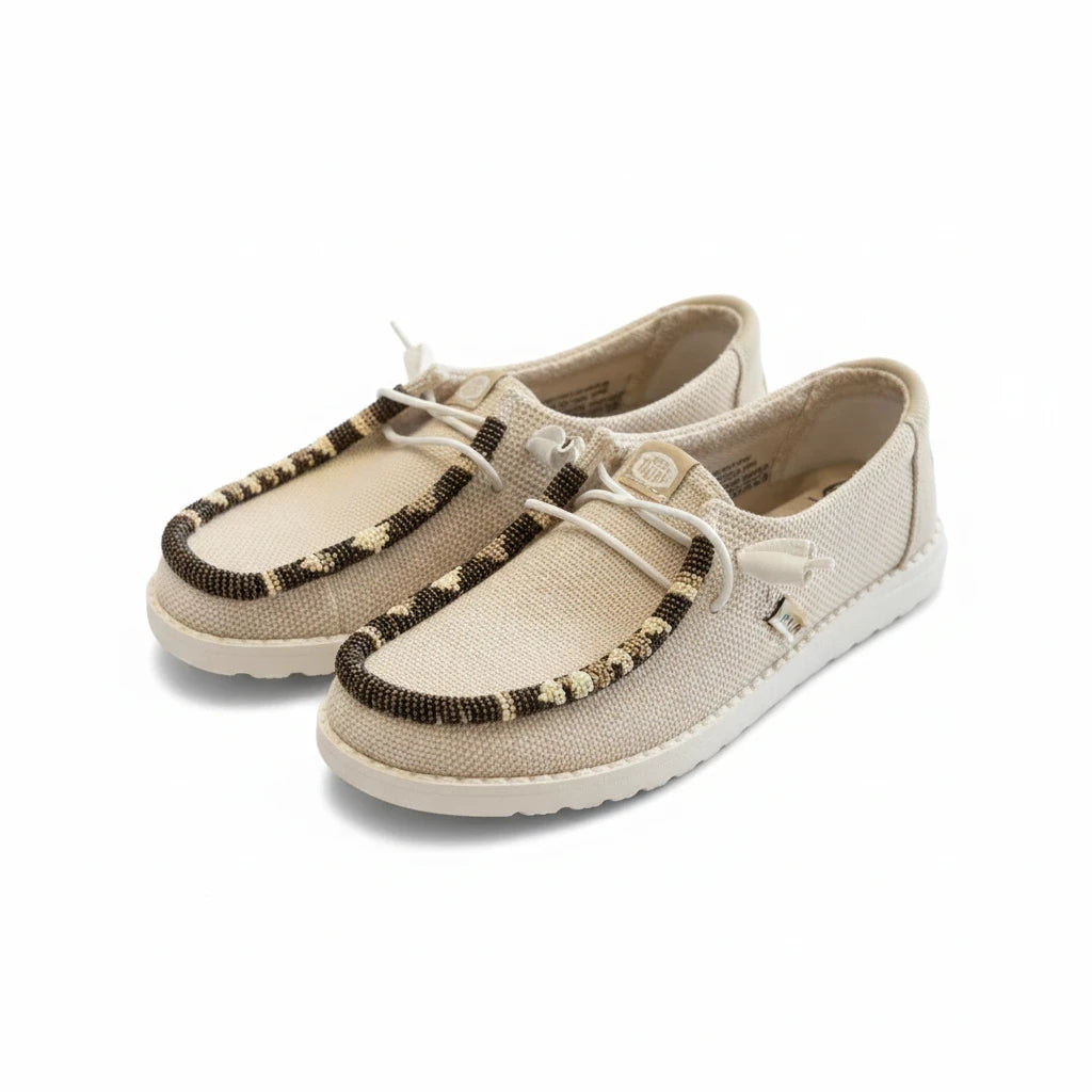 All Nations Designs &amp; More tan mesh Hey Dude slip-on shoes featuring unique hand-beaded trim in neutral tones.