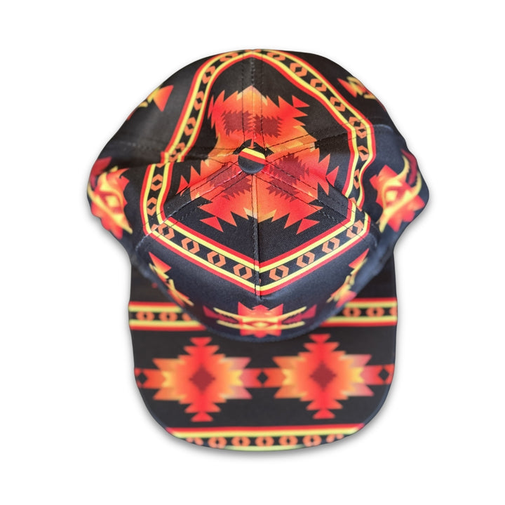 Top view of Black Mesa southwest flat bill snapback hat with symmetrical black, red, and gold geometric pattern details.