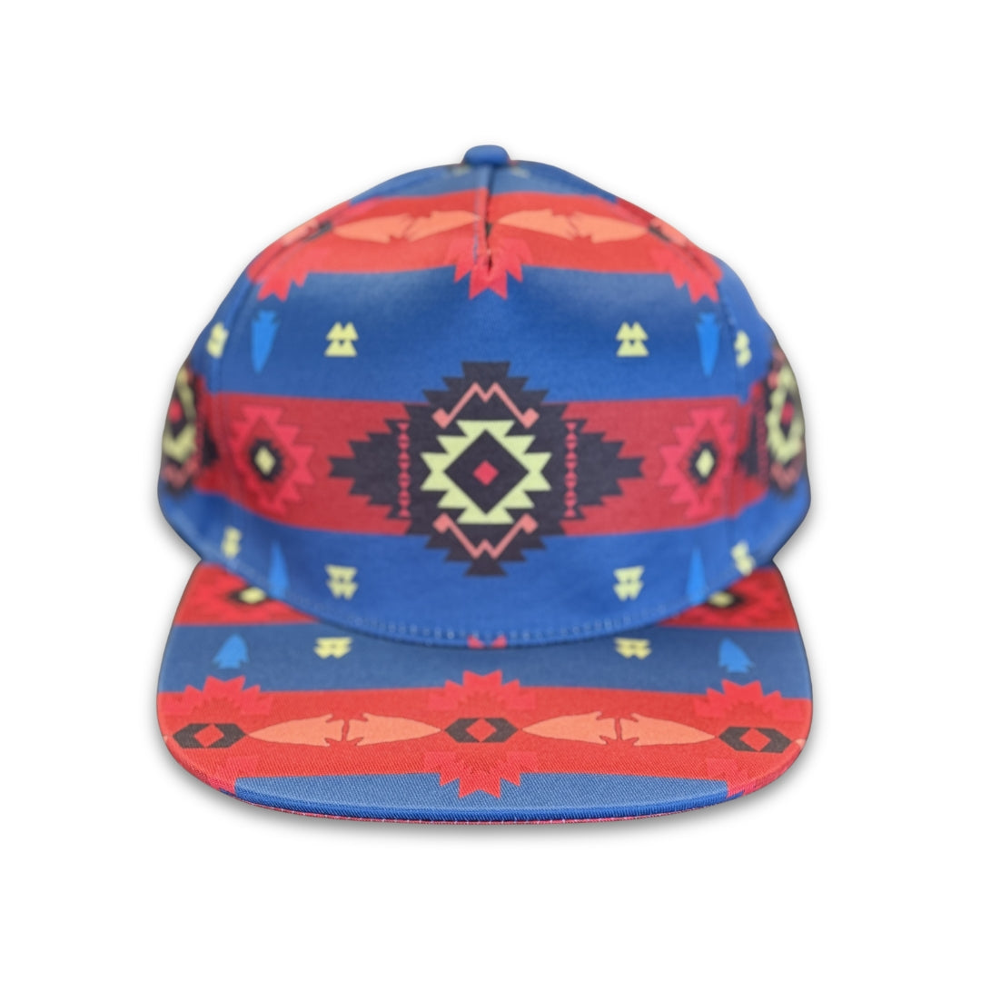 Blue Canyon southwest flat bill snapback hat with blue and red geometric western-inspired pattern shown from the front.