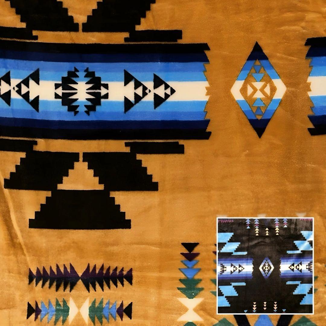 Buckskin Southwestern-style plush blanket with bold Native-inspired geometric diamond and stripe patterns.