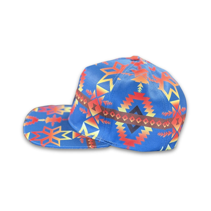 Side profile of Canyon Sky southwest flat bill snapback hat featuring bold blue geometric western-inspired patterns and flat brim design.