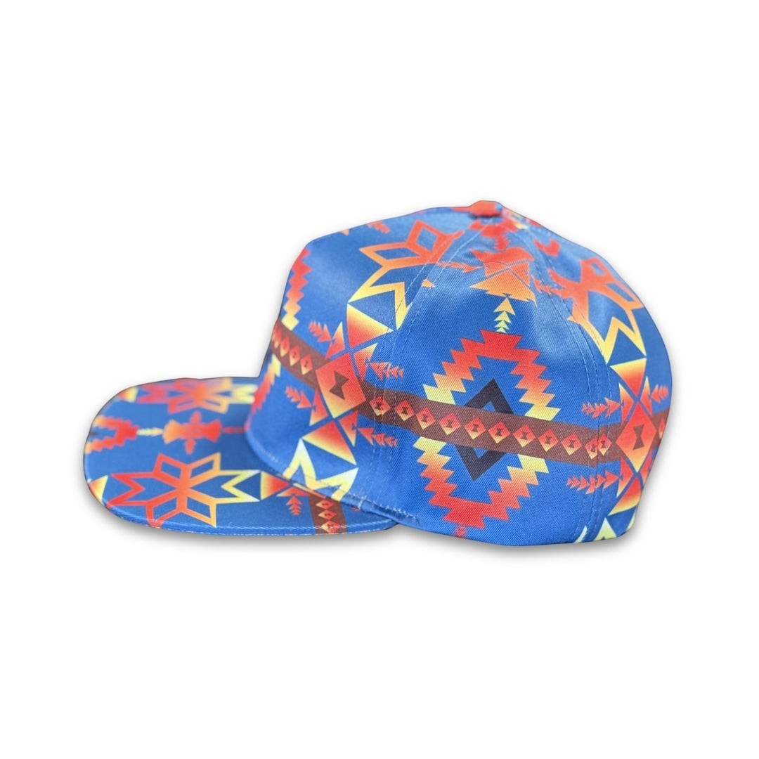 Side profile of Canyon Sky southwest flat bill snapback hat featuring bold blue geometric western-inspired patterns and flat brim design.