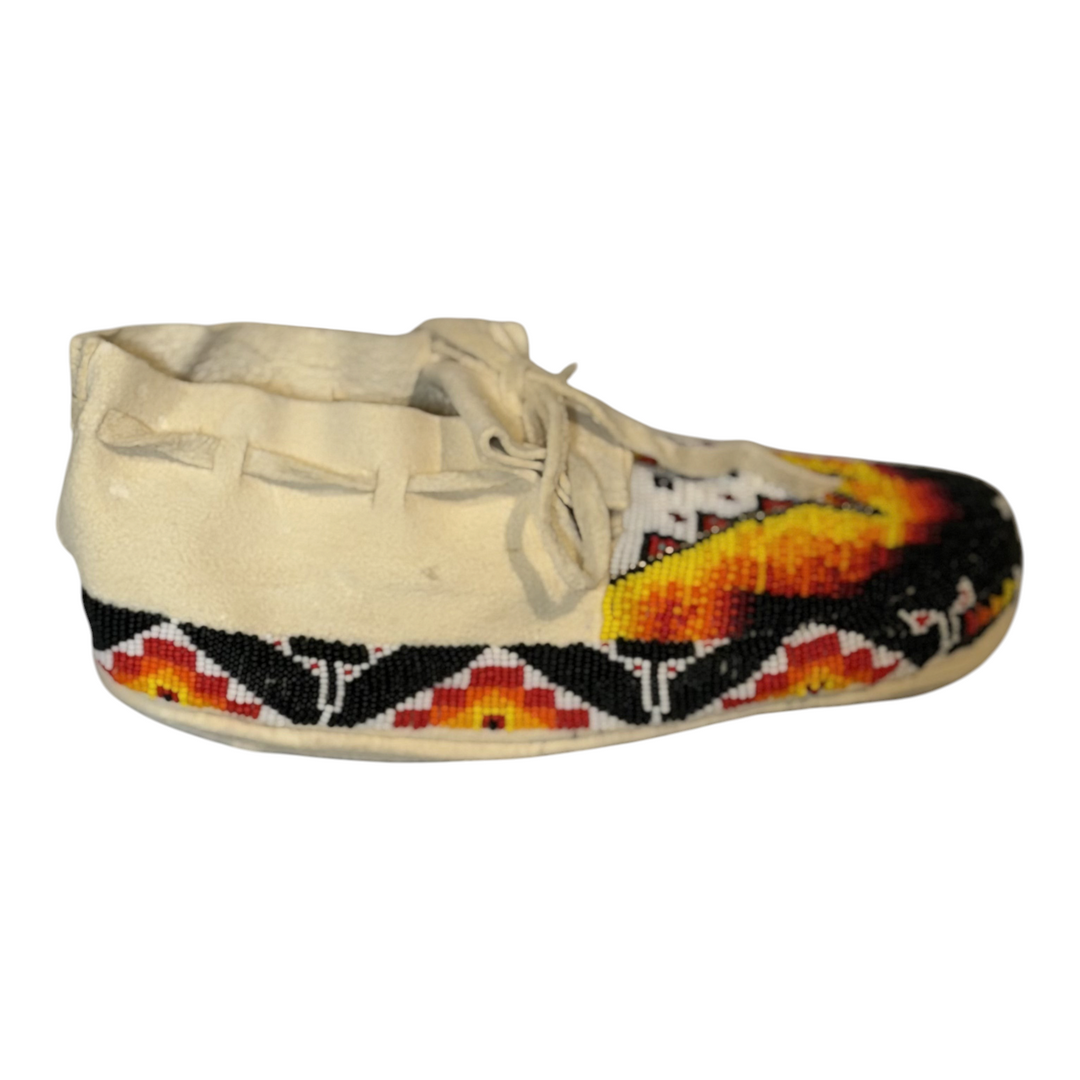 Opposite side view of a size 9.5 moccasin showing the beaded border and tie detail