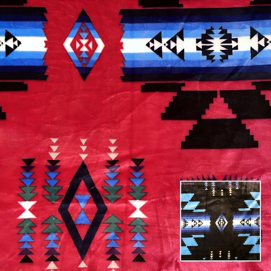 Hot pink Southwestern-style plush blanket with bold Native-inspired geometric diamond and stripe patterns.