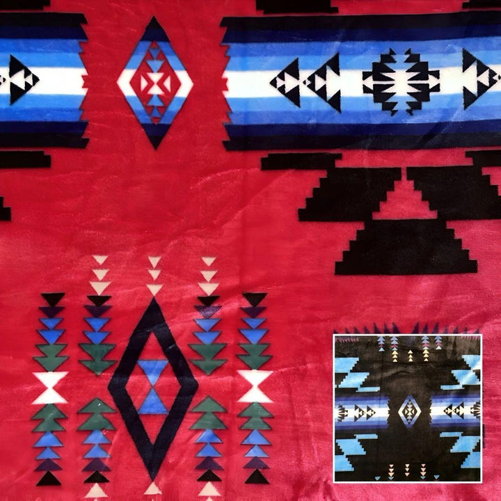Hot pink Southwestern-style plush blanket with bold Native-inspired geometric diamond and stripe patterns.