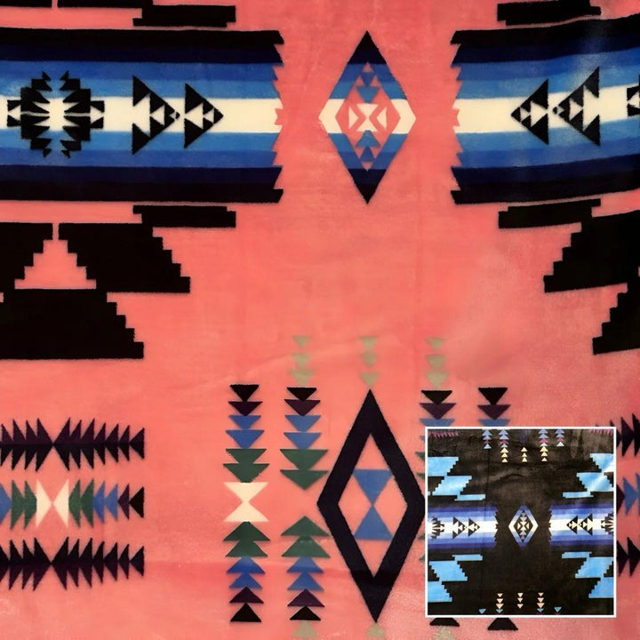 Light pink Southwestern-style plush blanket with bold Native-inspired geometric diamond and stripe patterns.
