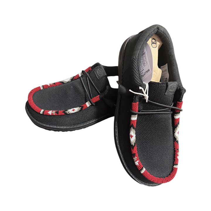 Angled view of the men’s size 8 black Wally pair showing the red, white, tan and black hand-beaded toe trim.