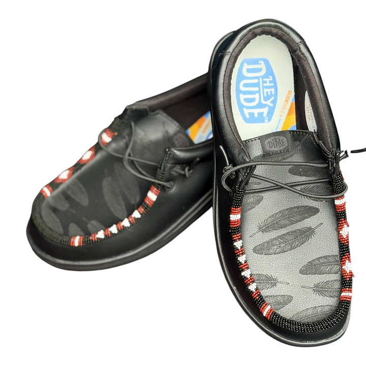 Men’s size 8 black leather Hey Dude Wally with laser-engraved feathers and black, red and white hand-beaded trim — angled pair