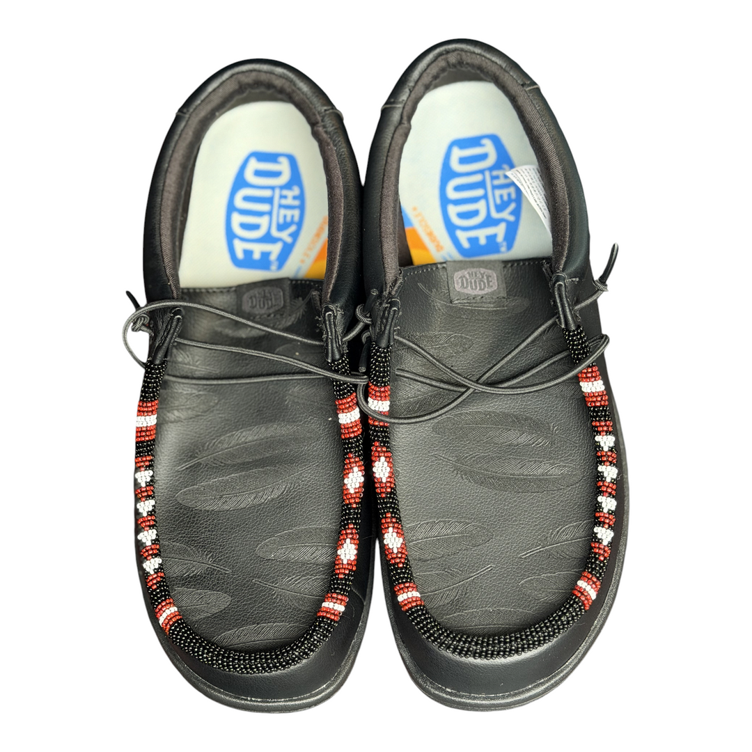 Men’s size 8 black leather Hey Dude Wally with laser-engraved feathers and black, red and white hand-beaded trim — engraved feather detail