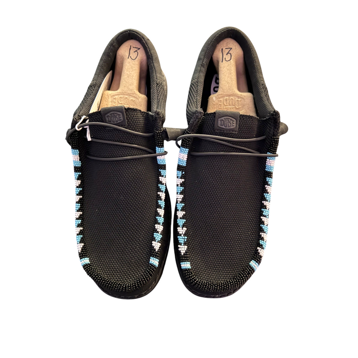 One-of-one men’s size 13 black mesh Hey Dude Wally shoes with light blue and pale pink hand-beaded trim, front view.