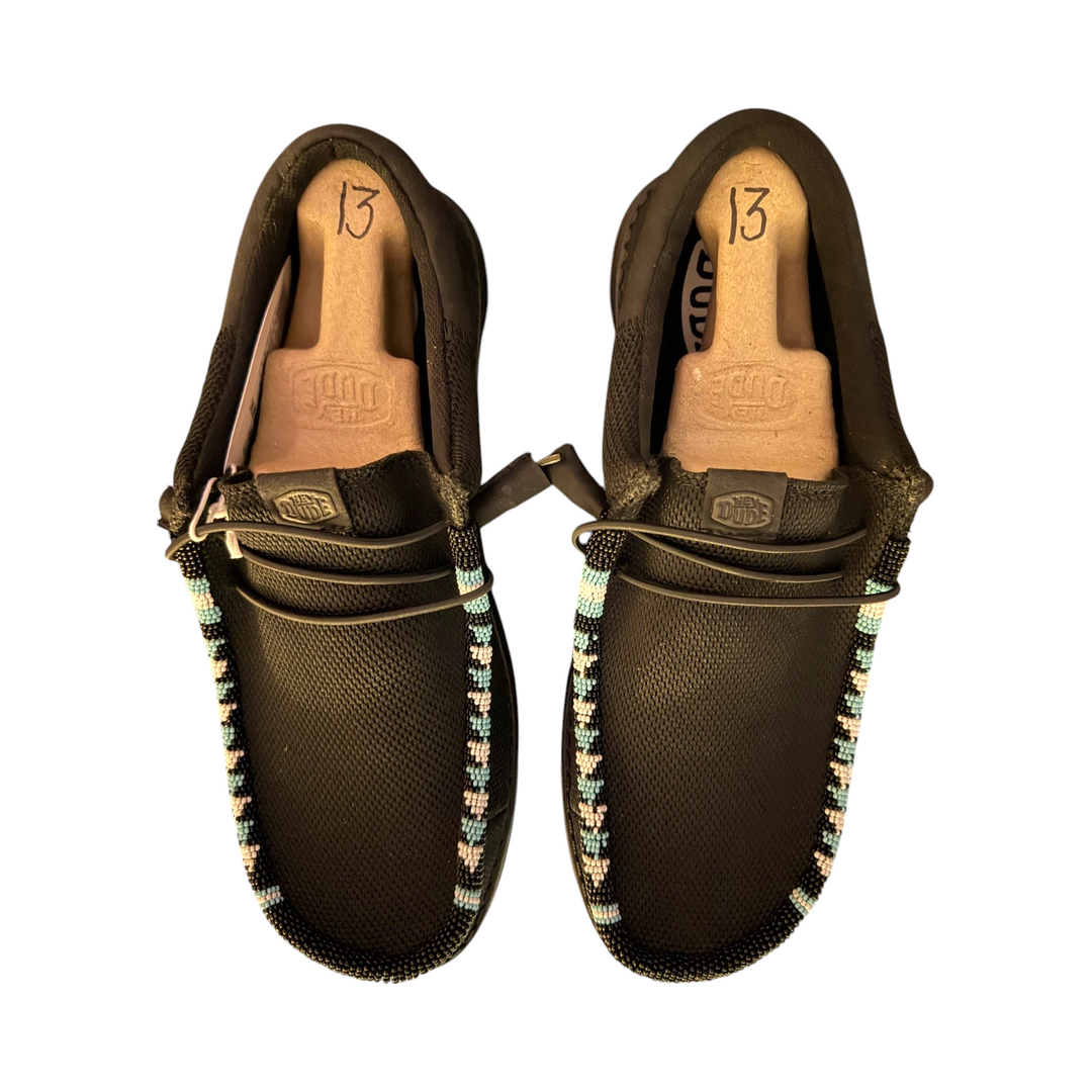 Top view of the one-of-one men’s size 13 black mesh Wally pair showing the beaded toe trim.