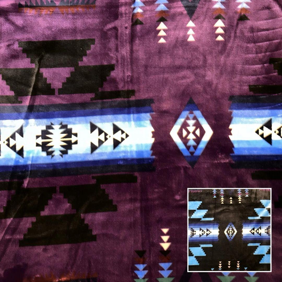 Purple Southwestern-style plush blanket with bold Native-inspired geometric diamond and stripe patterns.