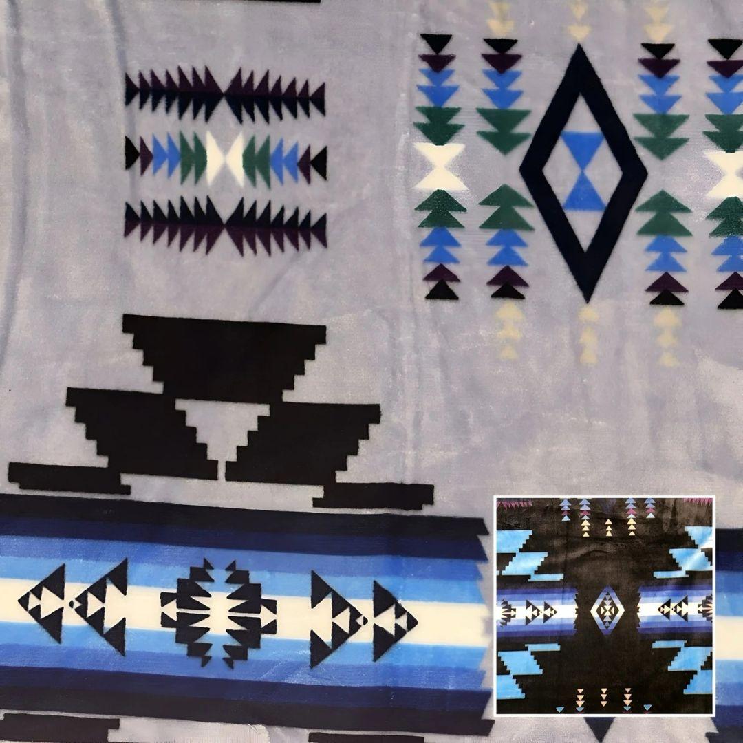 Silver Southwestern-style plush blanket with bold Native-inspired geometric diamond and stripe patterns.