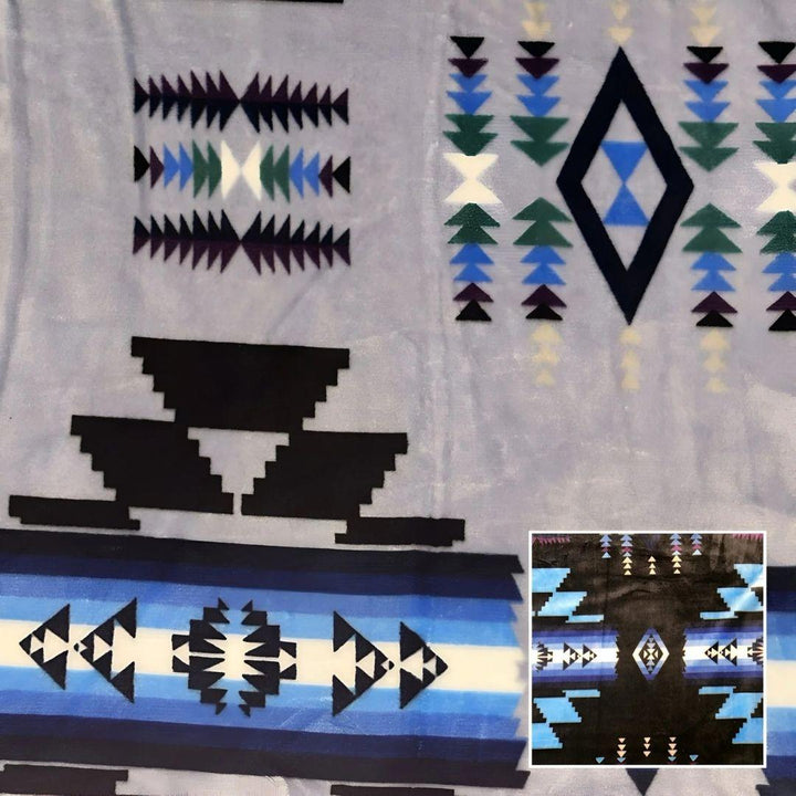 Silver Southwestern-style plush blanket with bold Native-inspired geometric diamond and stripe patterns.