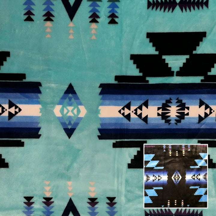 Teal Southwestern-style plush blanket with bold Native-inspired geometric diamond and stripe patterns.