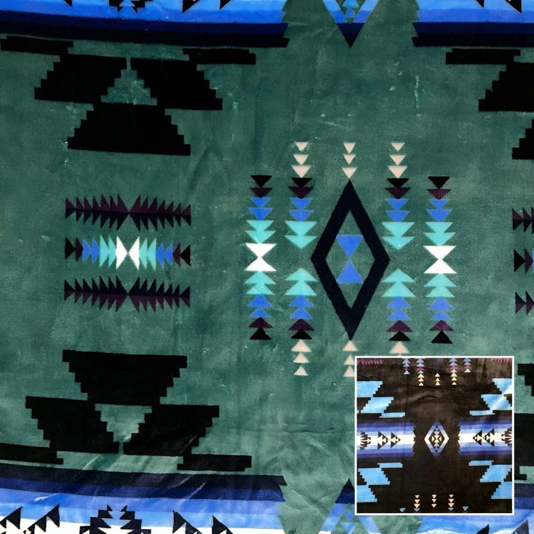 Turquoise Southwestern-style plush blanket with bold Native-inspired geometric diamond and stripe patterns.