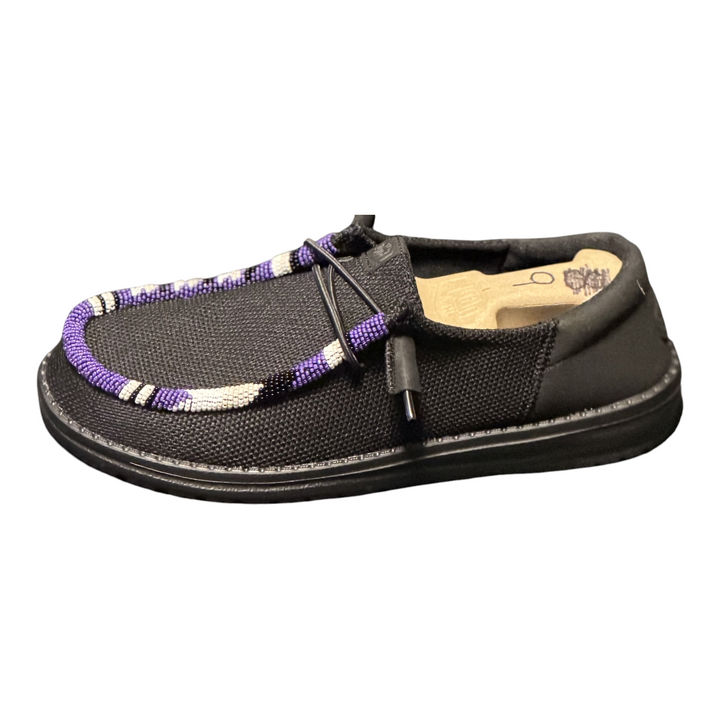 Women’s size 9 black Hey Dude Wendy shoes with purple, white and black hand-beaded trim — side profile detail