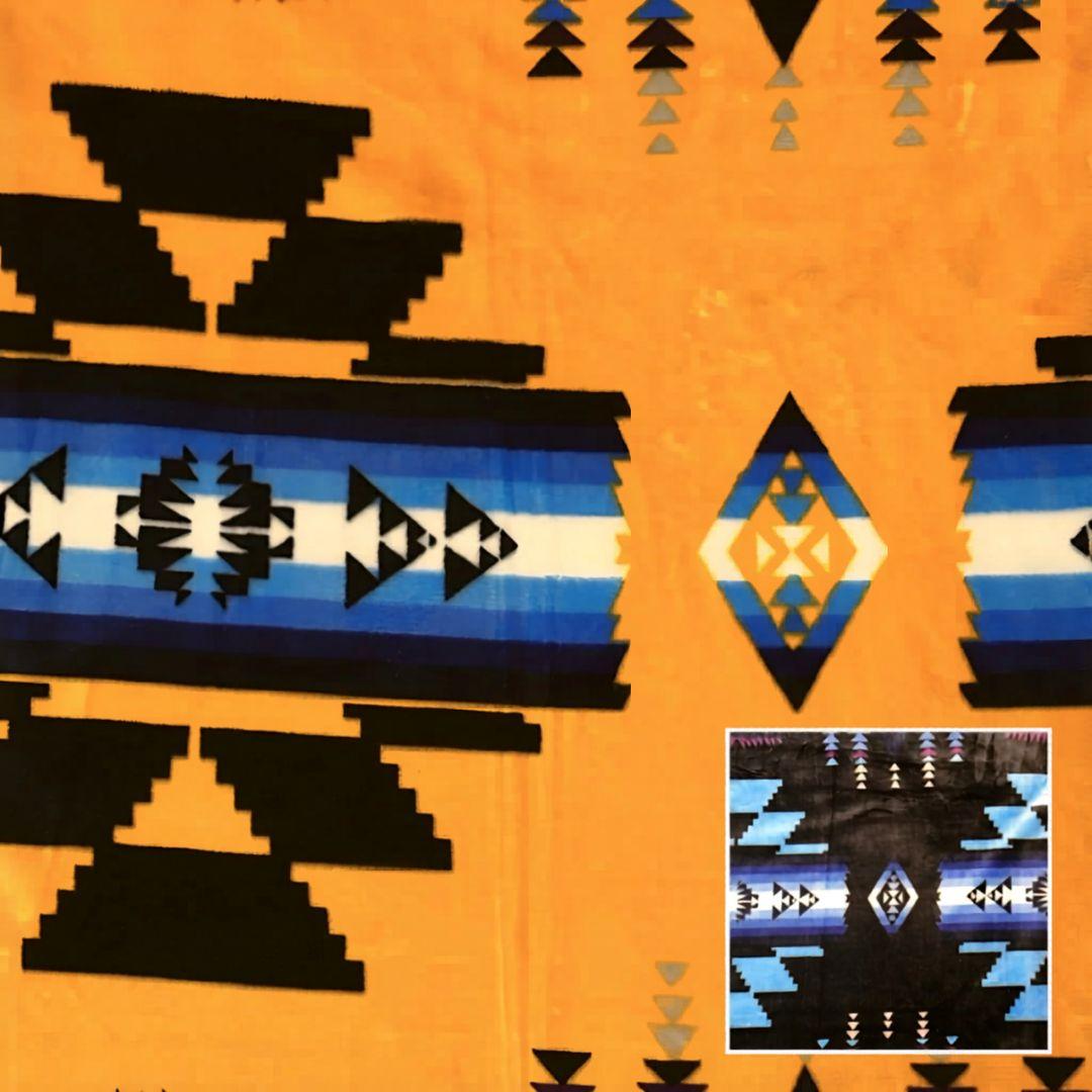 Yellow Southwestern-style plush blanket with bold Native-inspired geometric diamond and stripe patterns.